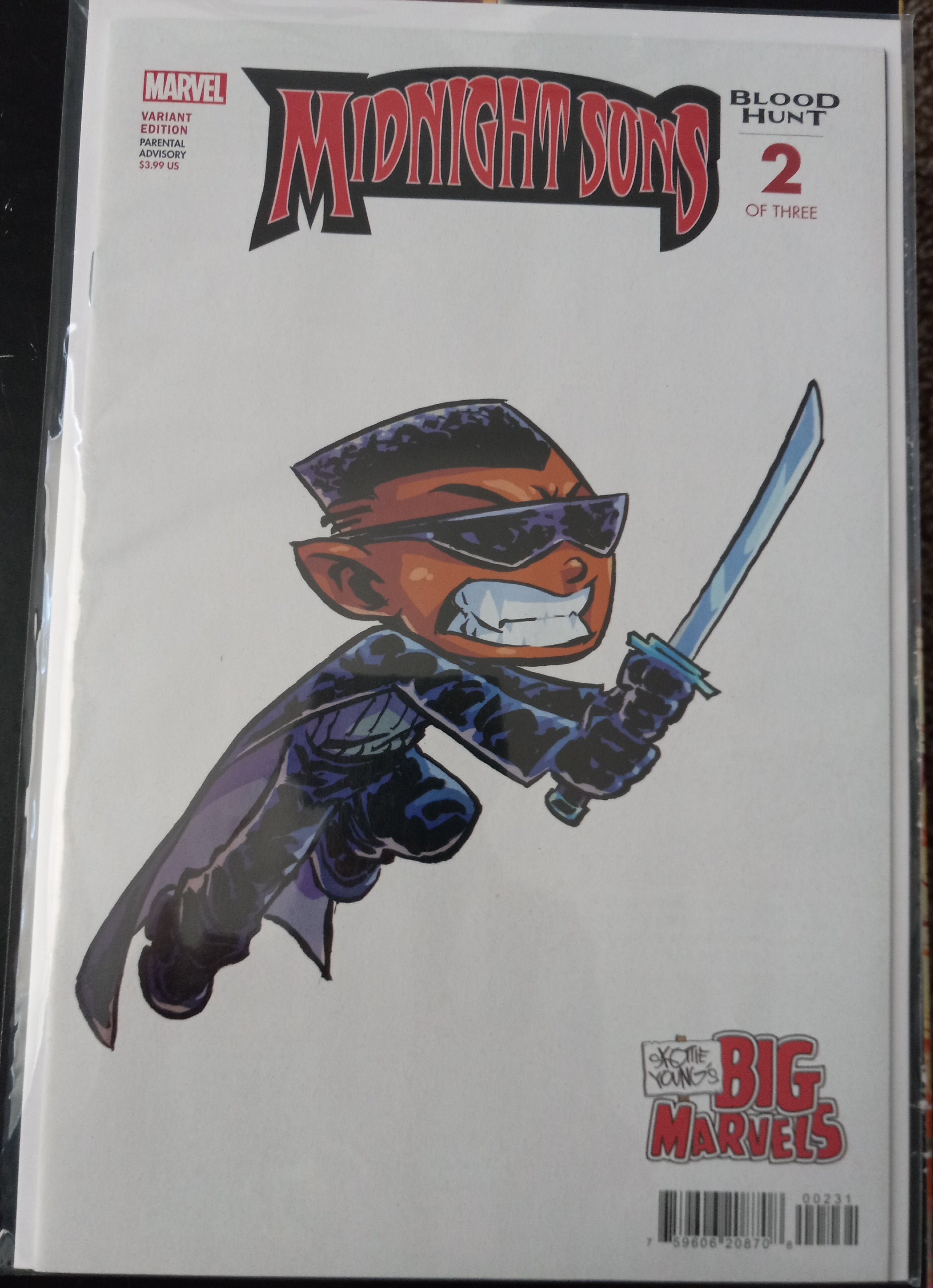 A comic book titled 'Midnight Sons: Blood Hunt 2 of 3' by Marvel, featuring a stylized cartoon illustration of a masked character in a dark outfit holding a sword on a white cover.